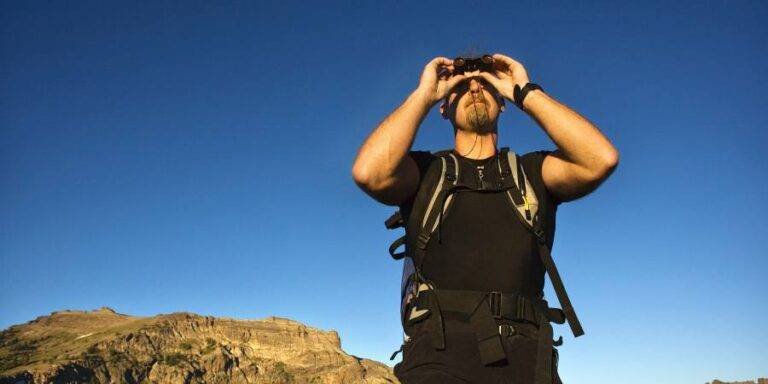 men watching something with binoculars during hiking