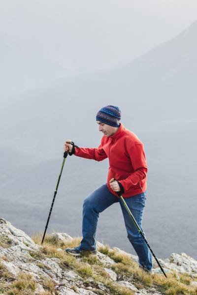 Man walking in hill with Hiking sticks